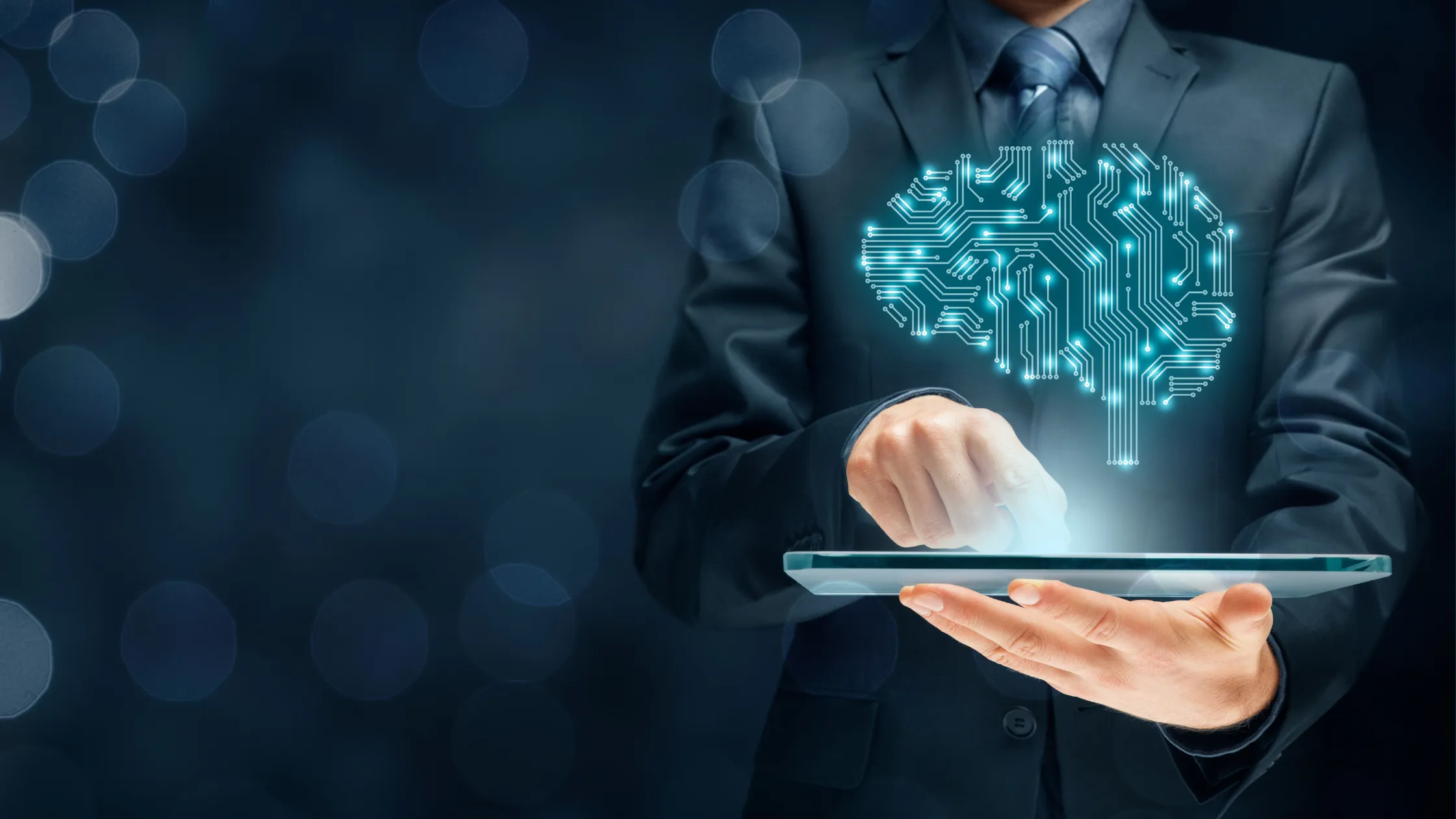 a person in a suit using a tablet with an image of a brain in blue computer connections